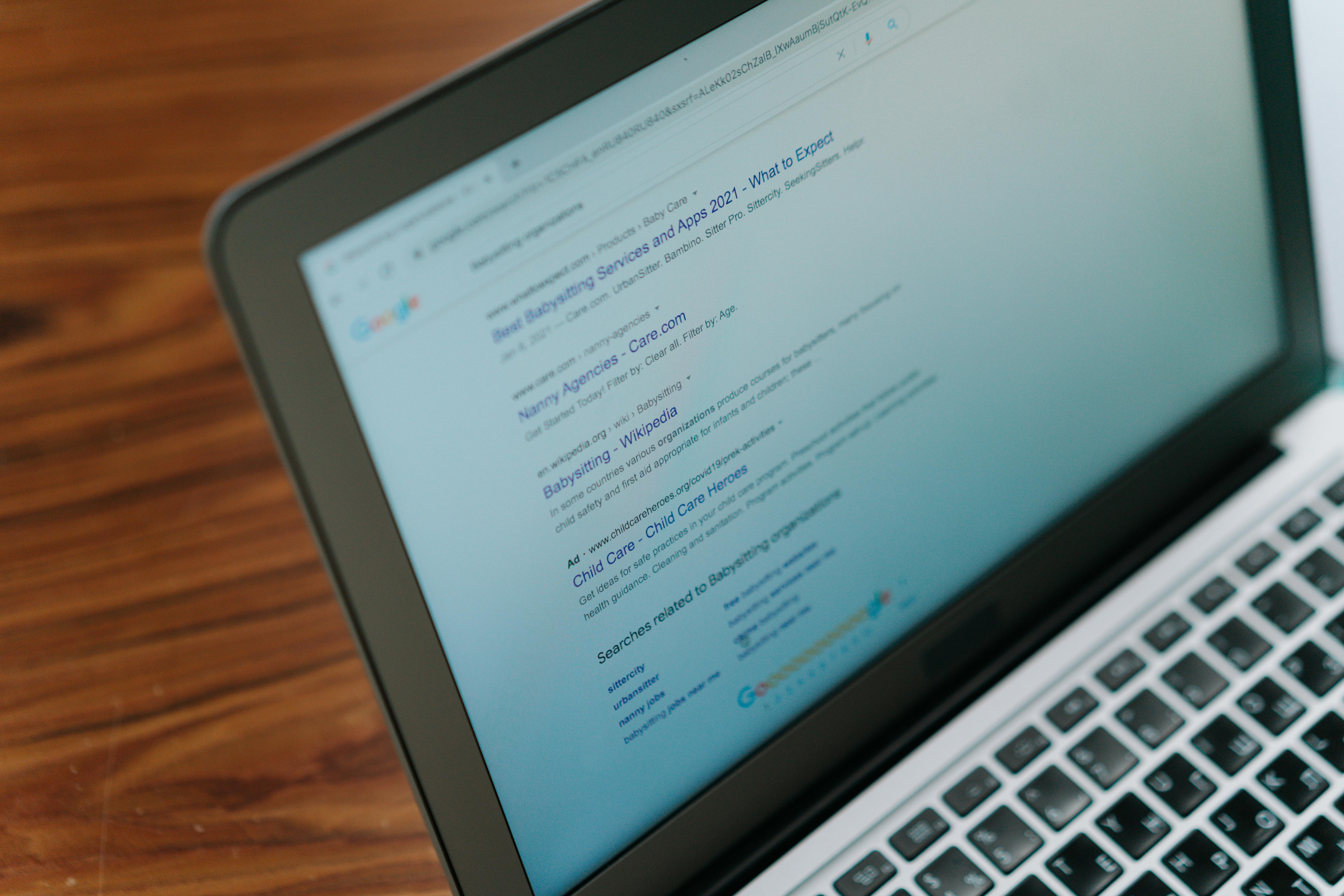 A laptop screen showing Google search results - profiles surfaced by search engines